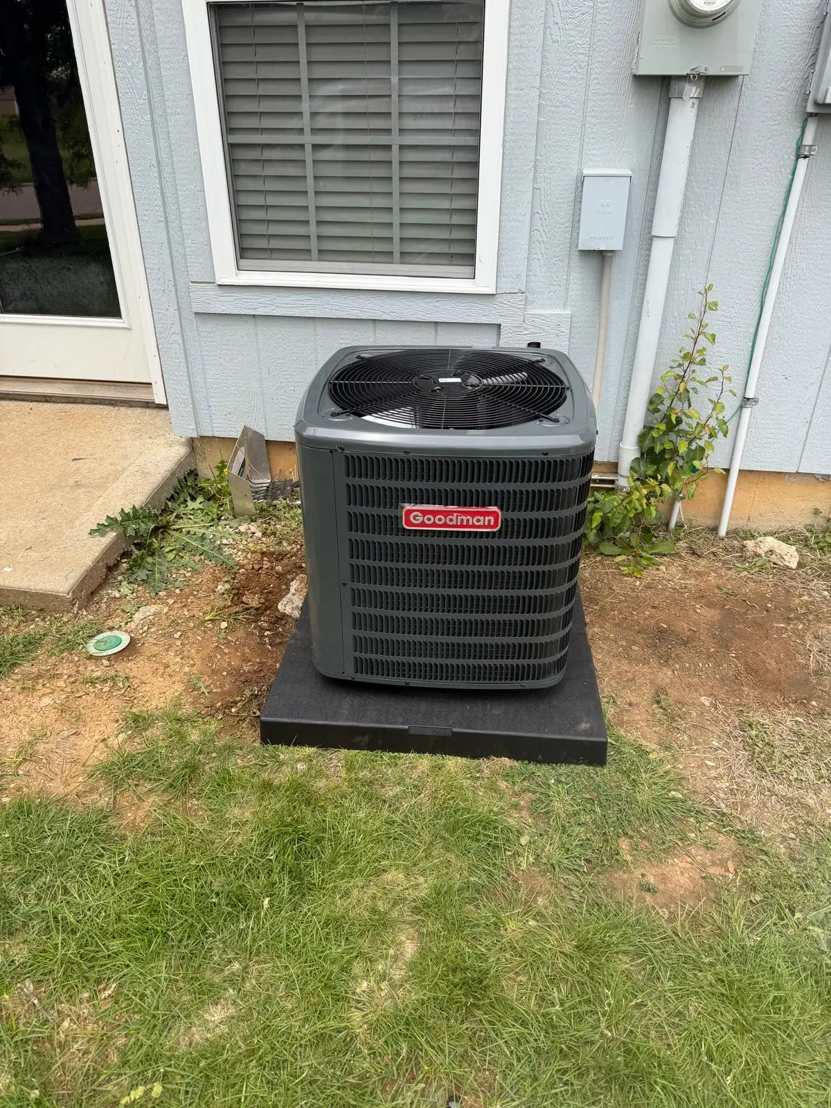 Goodman traditional condenser unit on equipment pad